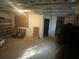 Unfinished basement offers potential with storage shelving, and exposed ceiling at 4865 Surrey Dr, Roswell, GA 30075