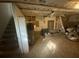 View of the unfinished basement showing the water heater, stairs, and exposed ceiling at 4865 Surrey Dr, Roswell, GA 30075