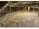 Crawlspace with vapor barrier shows the foundation supports and plumbing at 4865 Surrey Dr, Roswell, GA 30075