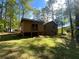 A house with an addition on the back with a partially shaded lawn at 4865 Surrey Dr, Roswell, GA 30075