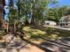 View of the yard and neighborhood with mature trees and manicured lawns at 4865 Surrey Dr, Roswell, GA 30075