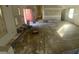 Living room with hardwood floors needing some love, a fireplace, windows, and open design at 4865 Surrey Dr, Roswell, GA 30075