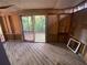 Outside porch with wooden railings, flooring, and views of the wooded lot with space for renovations at 4865 Surrey Dr, Roswell, GA 30075