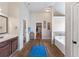 Bright bathroom features a soaking tub, separate vanities, and tiled flooring at 65 Waters Edge Ln, Covington, GA 30014