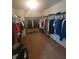 Walk-in closet with a brown carpet, shelving, and clothing racks for organized storage at 65 Waters Edge Ln, Covington, GA 30014