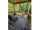 Enjoy the serene wooded views from this charming deck with comfortable seating and a fire pit for cozy evenings at 65 Waters Edge Ln, Covington, GA 30014