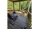 Enjoy the serene wooded views from this charming deck with comfortable seating and a fire pit for cozy evenings at 65 Waters Edge Ln, Covington, GA 30014