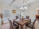 Formal dining room with wainscoting, chandelier and hardwood floors at 65 Waters Edge Ln, Covington, GA 30014