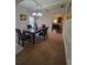Dining room with coffered ceilings, classic chandelier, and view into the kitchen at 65 Waters Edge Ln, Covington, GA 30014