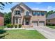 Charming two-story brick home featuring manicured lawn and two-car garage at 65 Waters Edge Ln, Covington, GA 30014