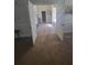 The hallway offers neutral walls and tan wood-look flooring throughout the home at 65 Waters Edge Ln, Covington, GA 30014