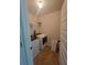 Functional laundry room with white washer, dryer, and storage shelves at 65 Waters Edge Ln, Covington, GA 30014