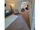 Cozy living room with neutral walls, carpet, a blue sofa, and large windows at 65 Waters Edge Ln, Covington, GA 30014