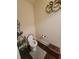 Cozy powder room with decorative elements and dark wood floors at 65 Waters Edge Ln, Covington, GA 30014