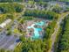 Aerial view of community pool, clubhouse, parking, surrounded by landscaping at 111 Springshade Ln, Canton, GA 30114