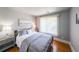 Bedroom featuring a comfortable bed, wood flooring, and a large window at 111 Springshade Ln, Canton, GA 30114