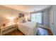 Comfortable bedroom with a cream colored bed, wood flooring, and light walls at 111 Springshade Ln, Canton, GA 30114