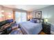 Cozy bedroom with a modern desk setup, a large window, and wood floors at 111 Springshade Ln, Canton, GA 30114