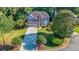 Well-maintained two-story home showcasing lush landscaping, a long driveway, and blue and brick facade at 111 Springshade Ln, Canton, GA 30114