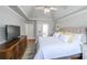 Well-lit bedroom featuring a vaulted ceiling, a ceiling fan and two dressers at 111 Springshade Ln, Canton, GA 30114