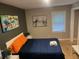Bedroom features a comfortable bed, modern art, and a window for natural light at 2148 Meador Se Ave, Atlanta, GA 30315