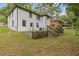 The exterior of this home features a lawn, trees, white siding, a door and several windows at 2148 Meador Se Ave, Atlanta, GA 30315