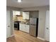 This kitchen features white cabinets, a tile backsplash, and stainless steel appliances at 2148 Meador Se Ave, Atlanta, GA 30315
