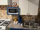 Cozy kitchen area with compact microwave, gas range and granite countertop at 2148 Meador Se Ave, Atlanta, GA 30315