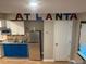 A well-lit kitchen showcasing stainless steel refrigerator, cabinets, and countertop with 'ATLANTA' signage at 2148 Meador Se Ave, Atlanta, GA 30315