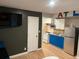 Living space with a modern kitchen, stainless steel appliances, and stylish blue cabinetry at 2148 Meador Se Ave, Atlanta, GA 30315