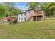 Back of house features a deck and outdoor access, all on a well maintained lawn at 2148 Meador Se Ave, Atlanta, GA 30315