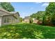 A large, well-maintained backyard with a lush lawn and mature trees, perfect for outdoor activities at 3171 Davis Rd, Marietta, GA 30062