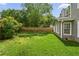 Beautiful backyard featuring well maintained lawn, tall wooden fence, and beautiful landscaping at 3171 Davis Rd, Marietta, GA 30062