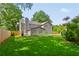 Backyard with beautiful lawn and fence, and partial view of home and patio area at 3171 Davis Rd, Marietta, GA 30062