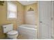 A clean and bright bathroom with a soaking tub and tiled wall at 3171 Davis Rd, Marietta, GA 30062