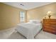 This bedroom offers carpet, a bed with white linens, and a wood dresser at 3171 Davis Rd, Marietta, GA 30062