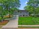 Traditional two-story home boasts a well-kept lawn, large trees and an attached two-car garage at 3171 Davis Rd, Marietta, GA 30062