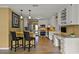 Bright kitchen with granite countertops, breakfast bar, stainless steel refrigerator, and hardwood flooring at 3171 Davis Rd, Marietta, GA 30062