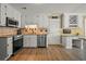 Well-lit kitchen featuring white cabinets, stainless steel appliances and granite countertops at 3171 Davis Rd, Marietta, GA 30062