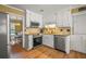 Well-lit kitchen featuring white cabinets, stainless steel appliances and granite countertops at 3171 Davis Rd, Marietta, GA 30062