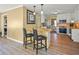 Bright kitchen with granite countertops, breakfast bar, stainless steel refrigerator, and hardwood flooring at 3171 Davis Rd, Marietta, GA 30062