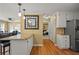 Bright kitchen with granite countertops, breakfast bar, stainless steel refrigerator, and hardwood flooring at 3171 Davis Rd, Marietta, GA 30062
