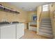 A spacious laundry room features side-by-side washer and dryer, and built-in shelving at 3171 Davis Rd, Marietta, GA 30062