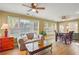 Open-concept living and dining area featuring bright windows, wood flooring and a ceiling fan at 3171 Davis Rd, Marietta, GA 30062
