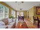 Open-concept living and dining area features wood floors, bright windows and a tan sofa at 3171 Davis Rd, Marietta, GA 30062