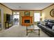 Living room featuring a brick fireplace, a black sofa, and neutral carpet at 3171 Davis Rd, Marietta, GA 30062