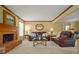 Bright living room boasts a brick fireplace, tan walls, and comfortable leather sofas at 3171 Davis Rd, Marietta, GA 30062