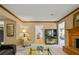 Cozy living room featuring a brick fireplace, neutral carpet, and decorative molding at 3171 Davis Rd, Marietta, GA 30062