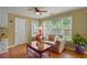 Bright living room with wood floors, tan sofa, a ceiling fan, and lots of natural light at 3171 Davis Rd, Marietta, GA 30062