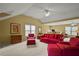 Large living room features a ceiling fan, many windows, and comfortable red couches at 3171 Davis Rd, Marietta, GA 30062